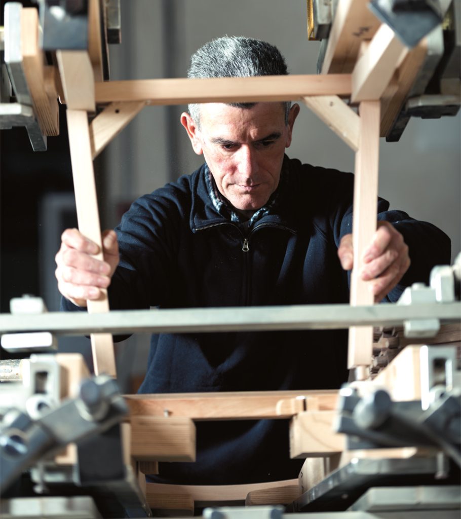 employee checks the structure of a chair in assembly